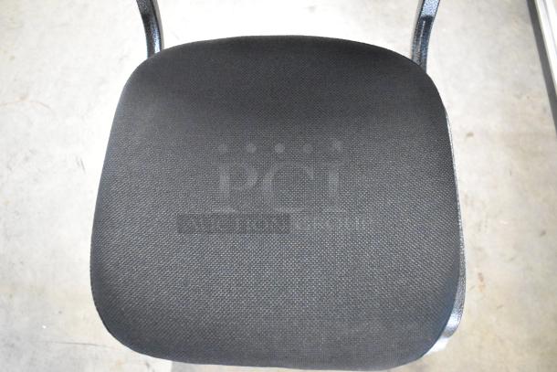 Black metal stackable banquet chair with black upholstered seat, new condition, slight scratch and dent marks on frame.