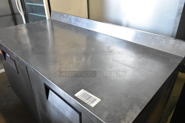 True TWT-60F stainless steel 2-door work top freezer on casters, 115V, 1 phase. Barcode visible. Good condition.