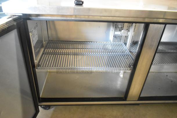 True TWT-60F stainless steel commercial 2-door worktop freezer on casters, featuring adjustable shelves, 115V, 1 phase.