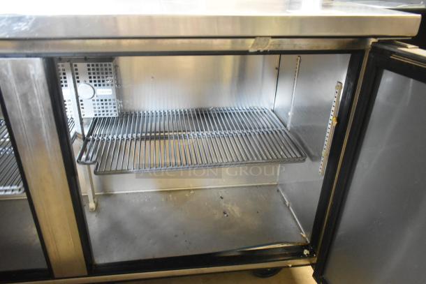 True TWT-60F stainless steel 2-door commercial freezer on casters, 115V, 1 Phase. Featuring interior shelving, visible wear.