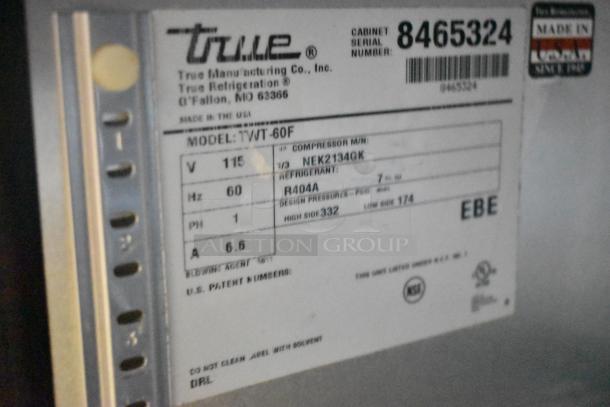 True TWT-60F stainless steel commercial 2-door worktop freezer with casters, 115V, model label shown with specs.