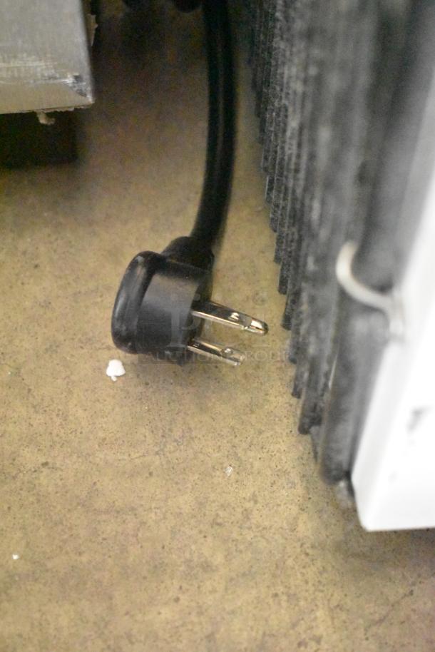 Power plug close-up for True TSCI-600R-G-PH single door cooler merchandiser, 115V, 1-phase, showing metal exterior.