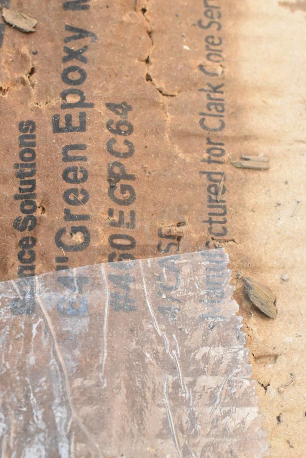 Close-up of a label on a cardboard box showing "460EGPC64 Regency 64" NSF Green Epoxy Mobile Shelving Post." Peeling plastic overlay.