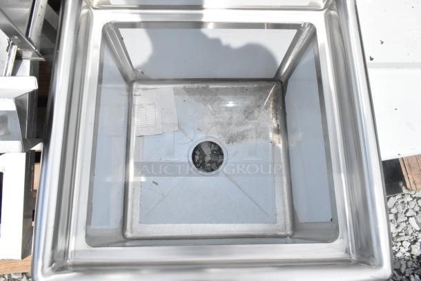Brand new Steelton 522CS11818N stainless steel single bay sink, visible scratches and dents, drain hole centered.