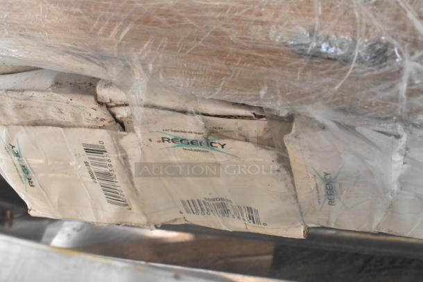 10 brand new scratch and dent Regency items wrapped, visible labels indicate models 600MBR48, 600DUN2048, 600LEGSS14.