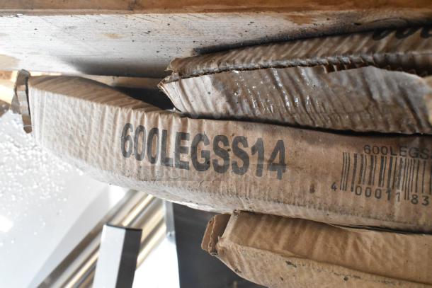 Box labeled "600LEGSS14" containing brand new Regency 18 1/2" stainless steel sink legs in original packaging, visible in a scratch and dent auction lot.