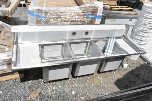 BRAND NEW Regency 600S31416212 stainless steel 3-bay sink with dual drain boards, scratch and dent condition, no legs.
