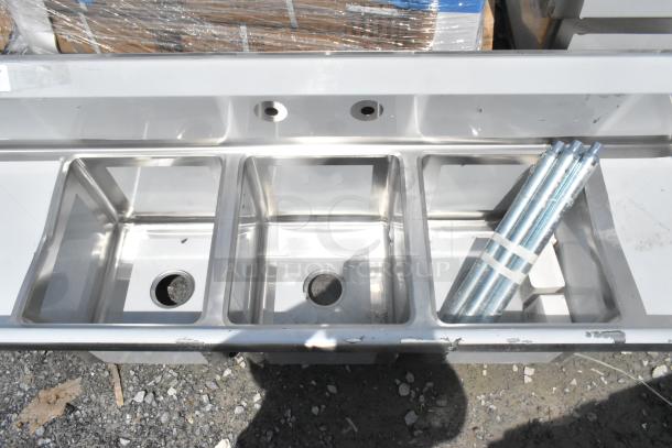 Brand new Regency 600S31416212 stainless steel 3-bay sink with dual drain boards, scratch and dent, missing legs.