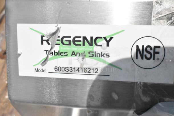 BRAND NEW SCRATCH AND DENT! Regency 600S31416212 stainless steel 3 bay sink with dual drain boards, no legs. NSF label visible.