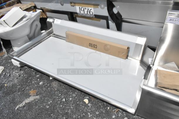 Brand new Regency 600CDT60L 5' clean dish table with left drainboard, 16 gauge steel. Minor scratches, dented edge.