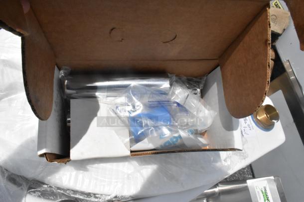 Brand new scratch and dent toilet with no tank, seen in open box. Includes installation parts in plastic packaging.