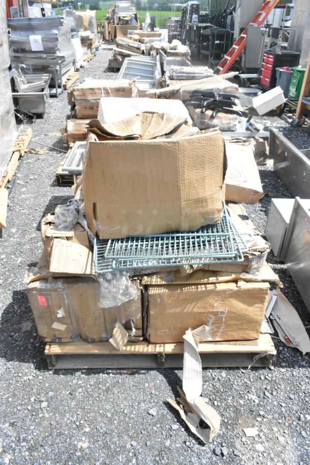 Pallet of new scratch and dent items including trays, organizer, platters, and schooner, in opened and damaged boxes.