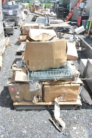 Pallet of new scratch and dent items including trays, organizer, platters, and schooner, in opened and damaged boxes.