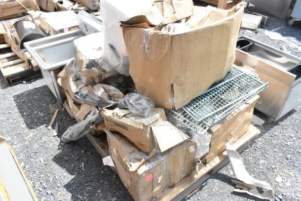 Boxes of various kitchen items, including trays, organizers, platters, and a schooner, in new scratch and dent condition.