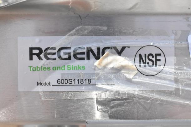 Regency 600S11818 stainless steel sink model label, indicating 23" size, 16-gauge stainless steel, NSF certified.