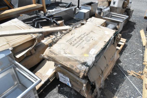 Boxes labeled "Regency 24x36 Green Epoxy Wire Drying Racks," scratched and dented, on pallets with stainless tables and seat cushions.