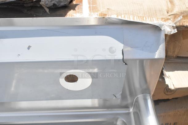 Brand new Regency 600S1181818L stainless steel single bay sink with left drain board, visible dents, no legs included.
