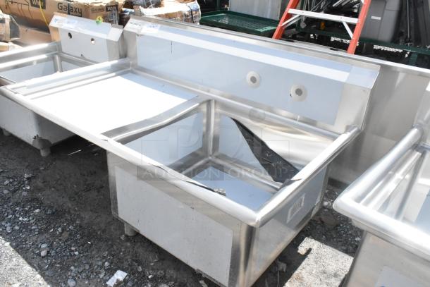 BRAND NEW SCRATCH AND DENT Regency 600S1232324L stainless steel single bay sink with left side drain board, missing legs.