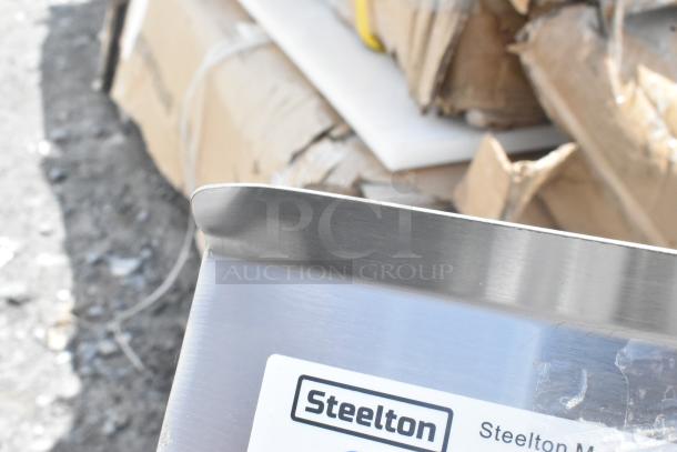 Brand new Steelton 23.5" 18-gauge stainless steel sink, model 522CS11818N, with visible scratches and dent.