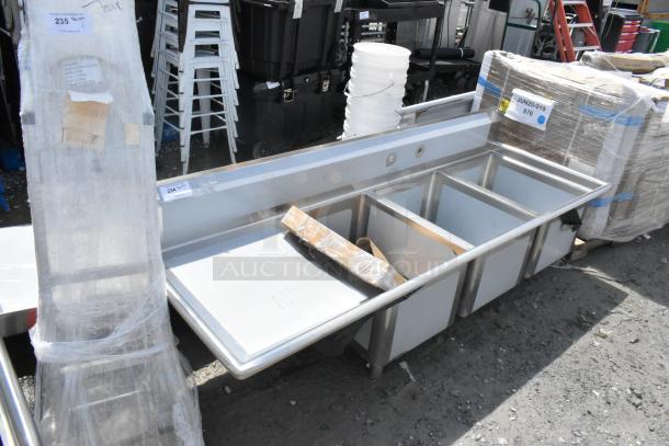 Brand new Regency 600S3182424L stainless steel 3 bay sink with left drain board; visible scratch and dent.