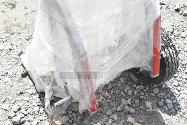 BRAND NEW Lavex 257SBHTS 550 lb. Hand Truck, aluminum, 10" pneumatic wheels, stair climbers, wrapped, on rough ground.