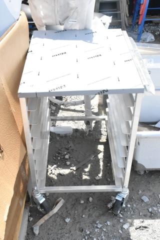 Brand new Regency 600UPR8WTELS 8 pan undercounter aluminum rack with stainless steel top; minor scratches and dents.