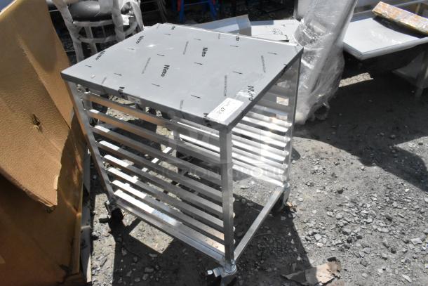 Brand new Regency 600UPR8WTELS aluminum bun pan rack, holds 8 pans, with stainless steel top, side channel. Scratch and dent condition.