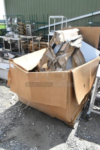 Box with 12 brand new scratch and dent items: stainless table, Metro shelves, and metal table visible.