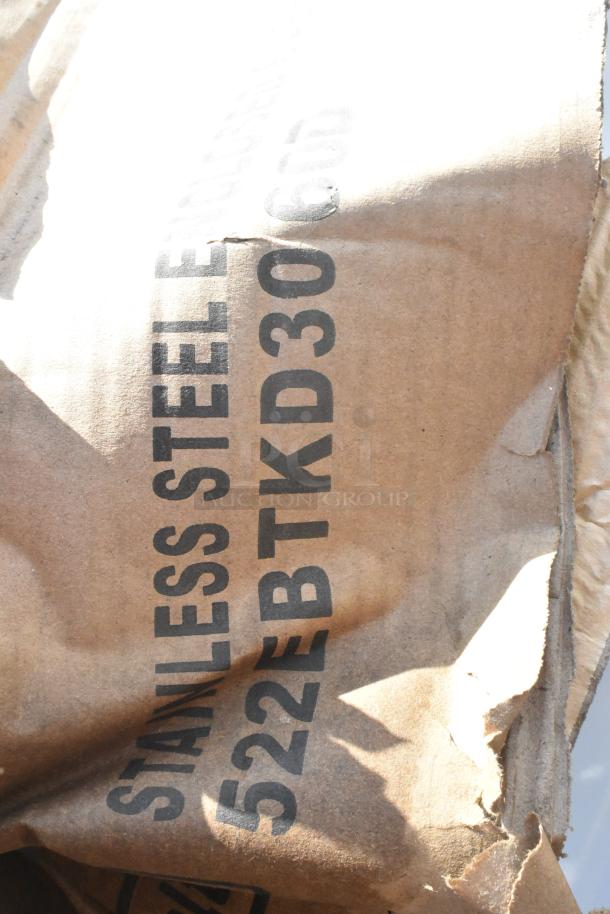 Brown paper packaging with "STAINLESS STEEL" and "522EBTKD30" markings, indicating stainless steel items inside.