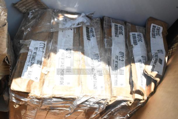 Boxes of scratch and dent items with visible labels indicating "QTY: 2 Post Kit Single Chrome Bracket."