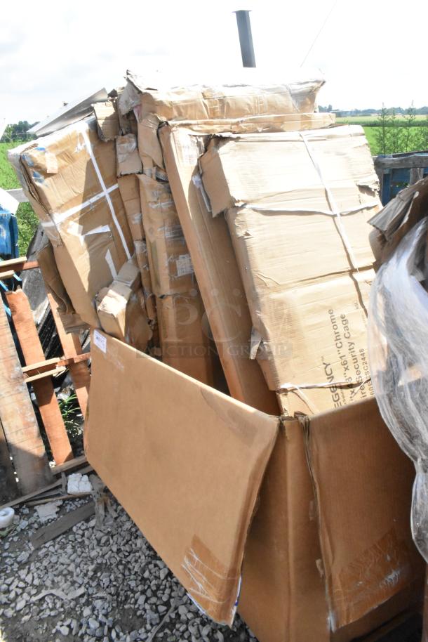 Cardboard boxes containing scratch and dent items, including security cage, tables, and shelves. Boxes show signs of wear.