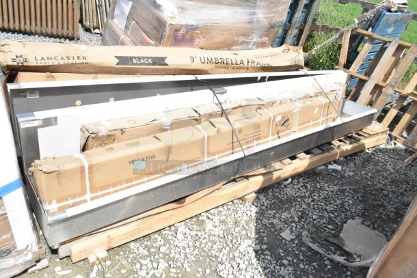 6 brand new scratch and dent items on pallets, including a wall mount sink, shelf, and umbrella frame. Lancaster Table & Seating box visible.