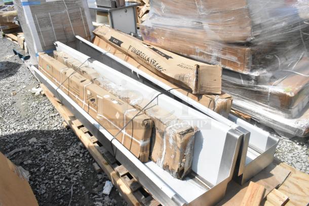 Brand new scratch and dent items including wall mount sink, over shelf, umbrella frame in original packaging.