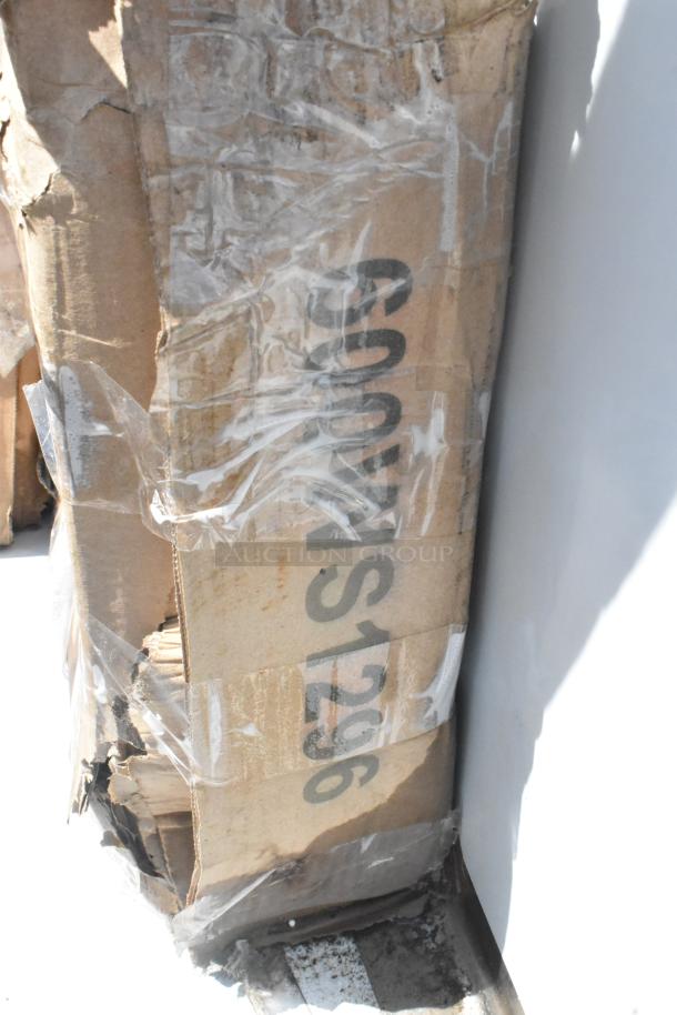 Damaged cardboard box labeled "S1296," containing new scratch and dent items, including a wall mount sink and umbrella frame.