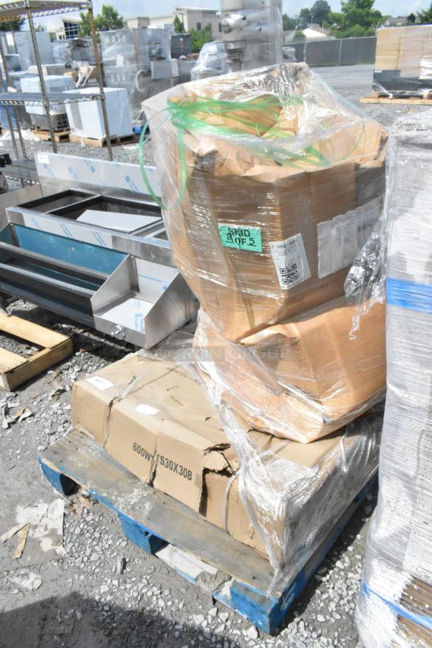 3 brand new scratch and dent items; stainless table, table base columns, pallet with wrapped boxes, marked "SKID 2 OF 5".