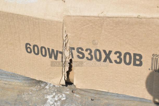 Cardboard box with "600WTS30X30B" label, indicating new scratch and dent items, including stainless table and base columns.