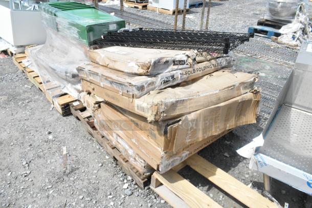 10 brand new scratch and dent items on pallets, including folding table and fan. Boxes show wear, items still in packaging.