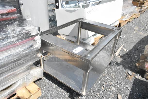 Stainless steel equipment stand with under shelf, on commercial casters. Good condition, visible tag reads "251".