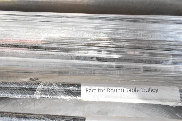 Pallet of round table trolley parts wrapped in plastic, labeled "Part for Round Table trolley," indicating type and function.