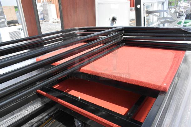Pallet of round table trolley parts, black metal frames, and red fabric bases, in new condition.