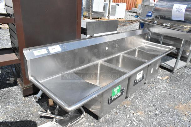 Regency 600S31515215 stainless steel 3 bay sink with dual drain boards, no legs, shown in used condition with visible labels.