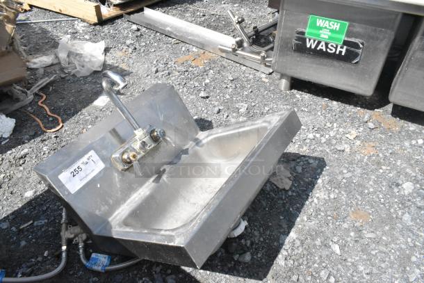 Stainless steel wall mount sink with faucet and handles, single bay, durable condition; label shows item number 255.