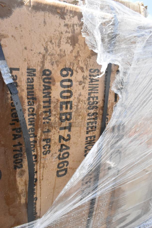 Cardboard box with "600EBT2496D" and "STAINLESS STEEL ENC" visible. Wrapped in plastic, indicating new item condition.