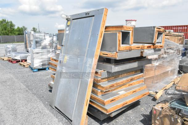 Norlake self-contained walk-in freezer parts, featuring a Copeland compressor and Norlake CPF150DC condenser, stored on pallets.