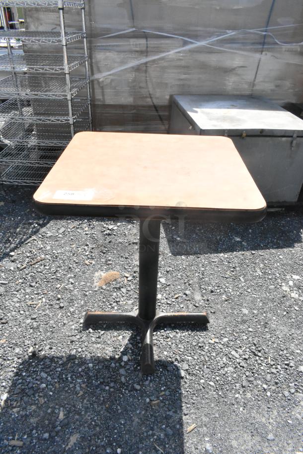 Square dining height table with a light wood top and black pedestal base. Slight wear visible. Label reads "259."