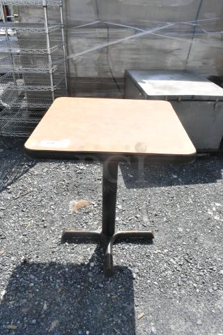 Square dining height table with a light wood top and black pedestal base. Slight wear visible. Label reads "259."