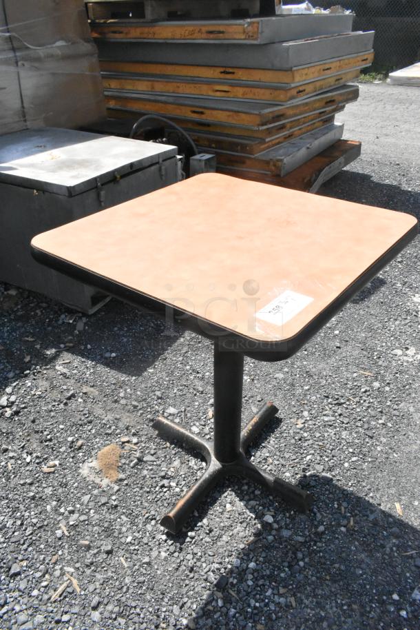 Square dining height table with a light brown top and black metal pedestal base, marked "338" on surface.