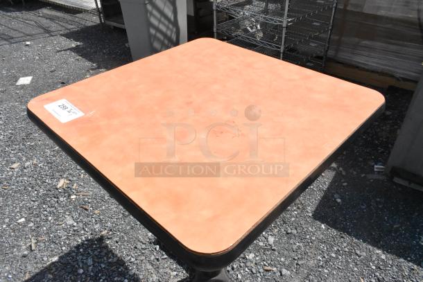 Square dining height table with light wood finish, visible wear, metal base. Auction tag reads "259".
