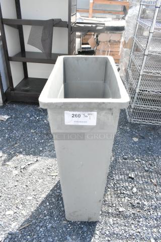 Gray Poly Slim Jim Trash Can, rectangular shape, visible label indicating item number 260, outdoors, in used condition.