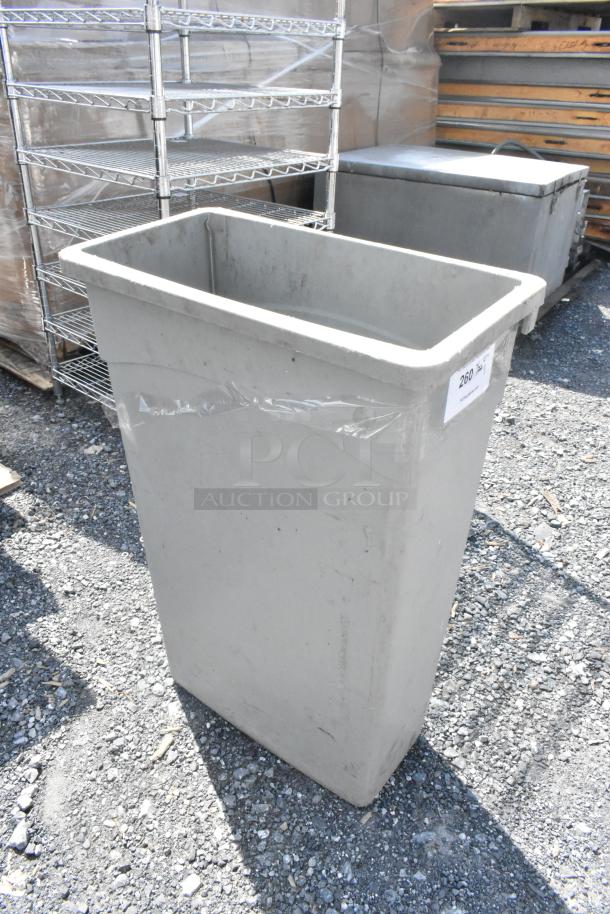 Gray Poly Slim Jim trash can, rectangular, outdoor setting, minor wear, label number "260" on side, durable design.